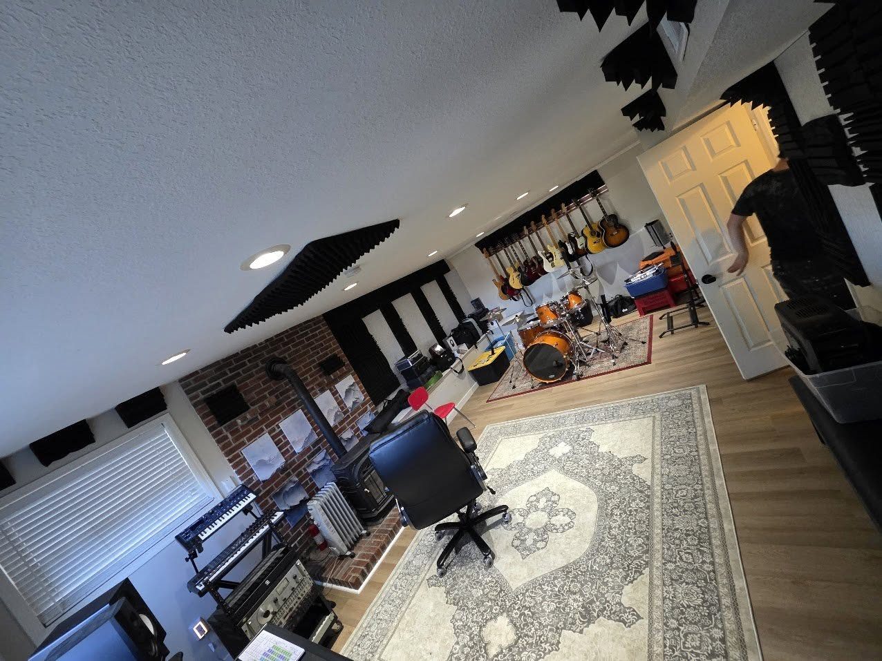 Studio live room with guitar wall, drum kit and acoustic treatment